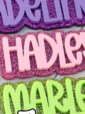 Custom acrylic name keychain with glitter background and bold laser engraved lettering