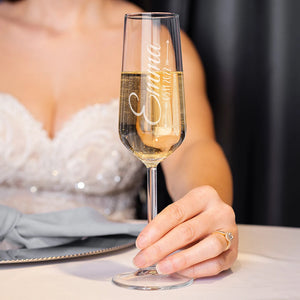 Romantic wedding toast with personalized champagne flutes and golden bubbles