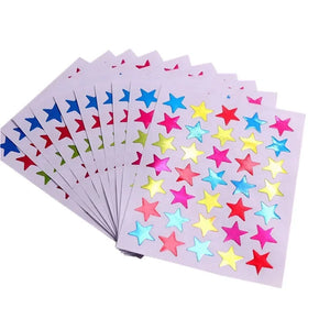Star reward stickers placed on kids homework notebooks to encourage effort and learning