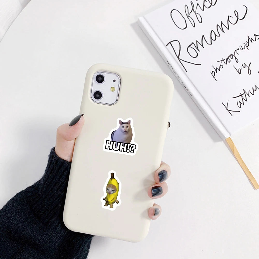 Cute cat meme stickers decorating laptop and phone with playful cartoon designs