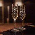 Personalized champagne flutes with couple names engraved on clear glass