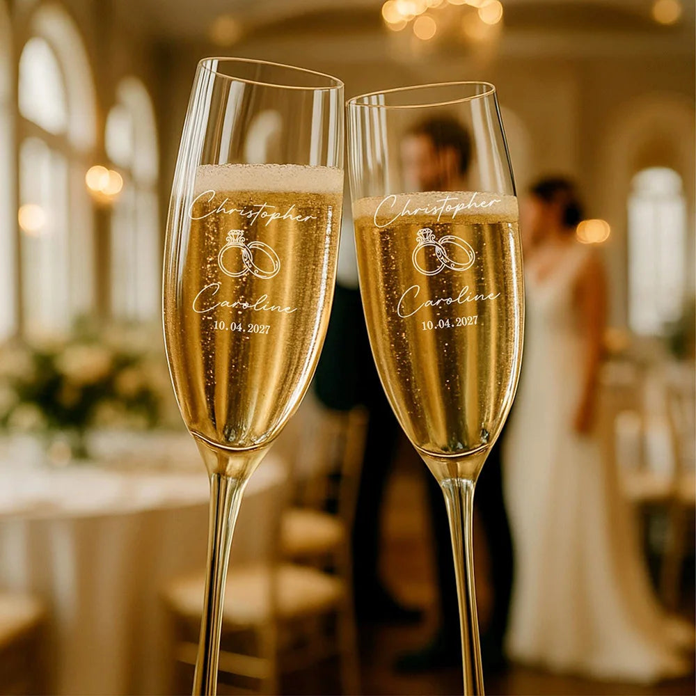 Personalized champagne flutes displayed on wedding table with elegant décor
