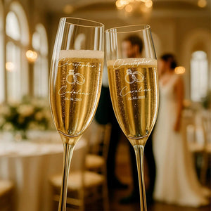 Personalized champagne flutes displayed on wedding table with elegant décor